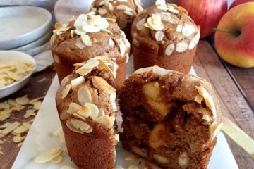 photo culinaire d'un muffin à la pomme, aux amandes et à la cannelle, tranché sur une planche en marbre blanc