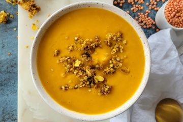 photo culinaire d'un velouté de patate douce et lentilles corail au curry et crème de coco avec un crumble salé au curry