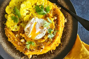 photo culinaire d'une purée de courge et oeuf poché avec du chou-fleur rôti et du quinoa croquant avec des noisettes